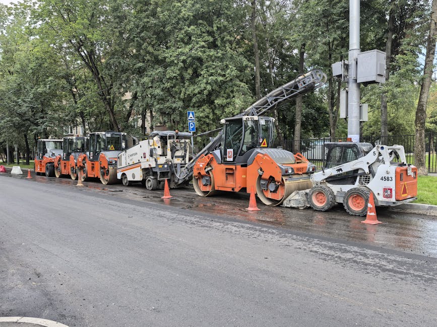 A cracked and partially collapsed rural road with orange cones blocking one lane